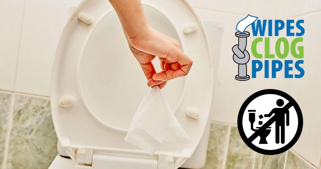 Toilet paper being disposed of in a toilet with a "Do Not Flush" label for wipes, promoting proper w.