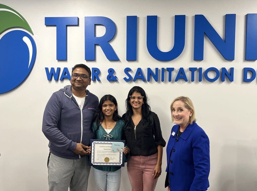 jessica-joel-family-winning-artwork Triunfo Water & Sanitation District team celebrating 2023 achievements.