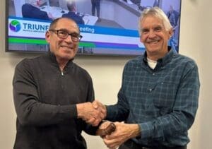 Leon Shapiro and James Wall shaking hands
