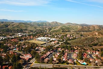 Aerial view of Triunfo Water & Sanitation District with residential neighborhoods and rolling hills.