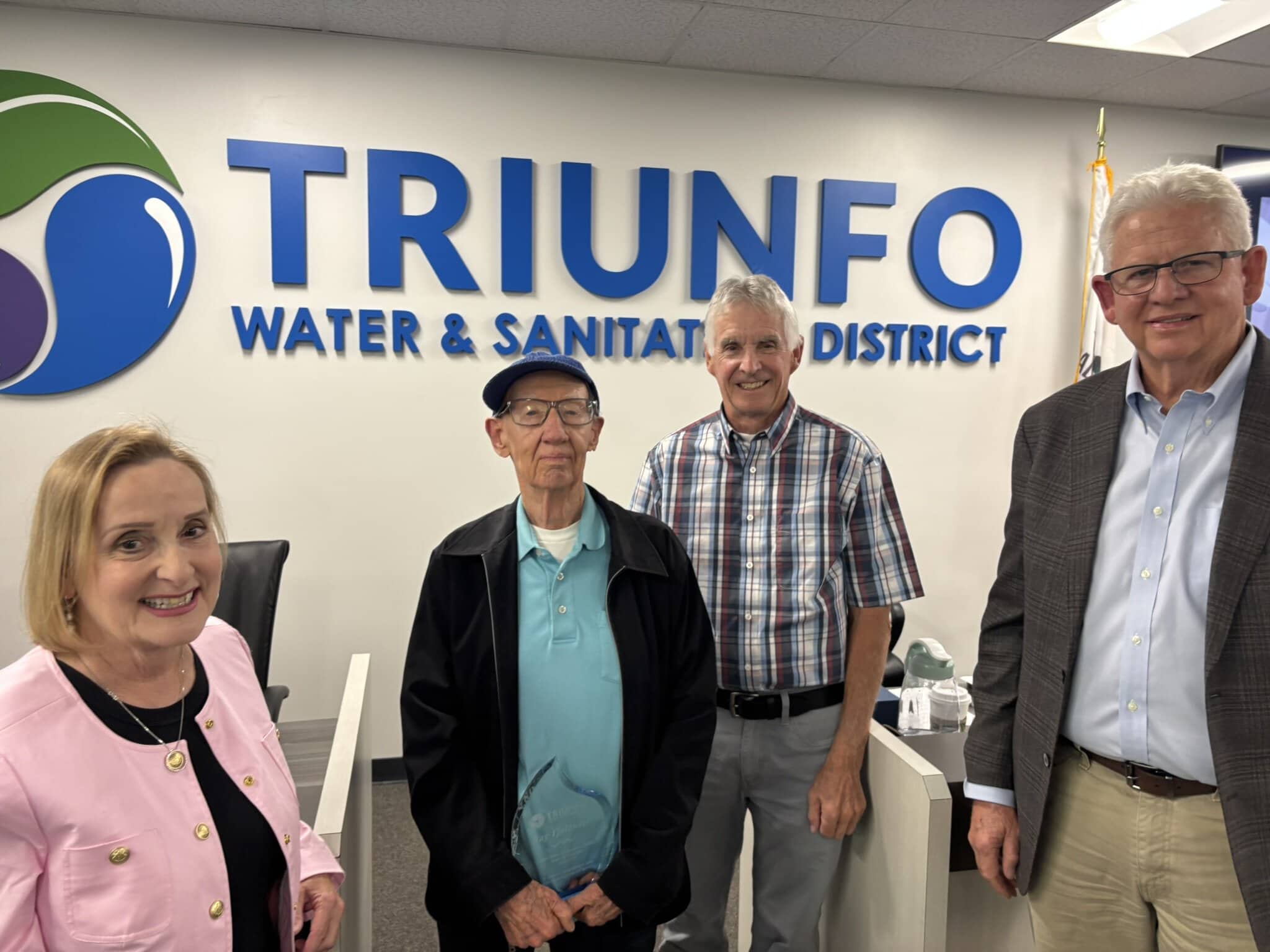 Jane Nye, Ray Tjulander, James Wall and Mark Norris standing in front of Triunfo Water & Sanitation District sign.